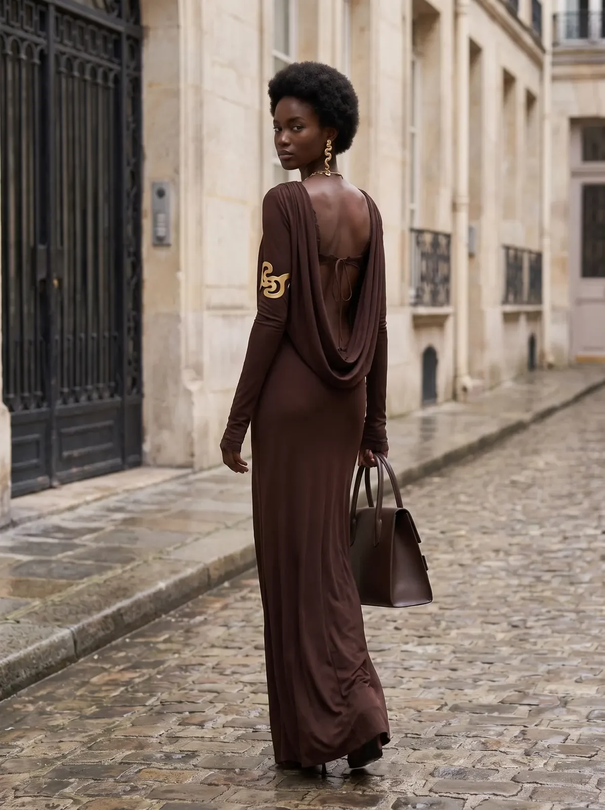 Rear view of the gown showing its open back and draped fabric